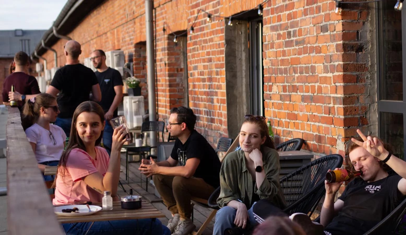 Revolve Healthcare office terrace A group of Revolve Healthcare employees chilling on the terrace of the company’s office with the building wall made of exposed red bricks
